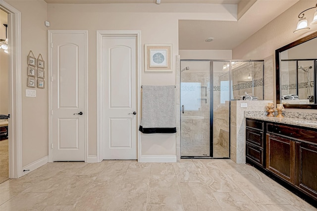 bathroom featuring vanity and a shower with shower door