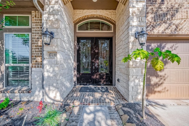 view of exterior entry with a garage