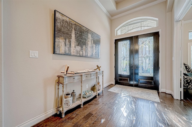 foyer featuring dark hardwood / wood-style flooring, french doors, and ornamental molding