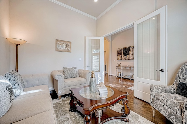 living room featuring crown molding and hardwood / wood-style flooring