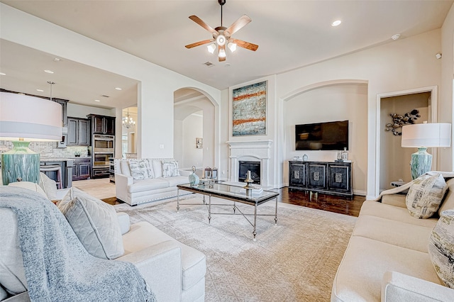 living room with ceiling fan and light hardwood / wood-style floors