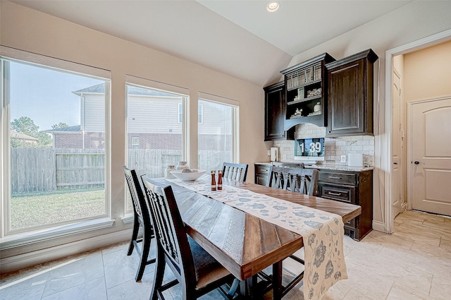 dining area with plenty of natural light and lofted ceiling