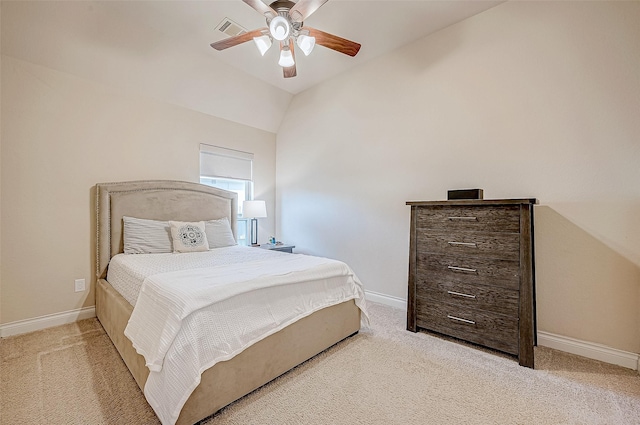 bedroom featuring ceiling fan, light carpet, and vaulted ceiling