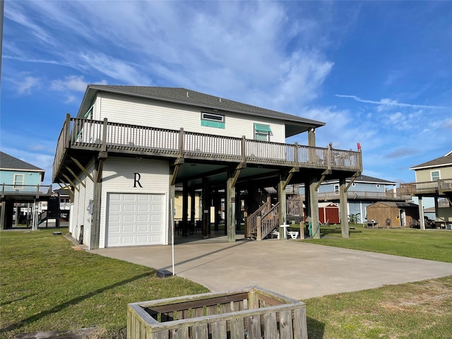 view of front of home with a wooden deck, a front yard, and a garage