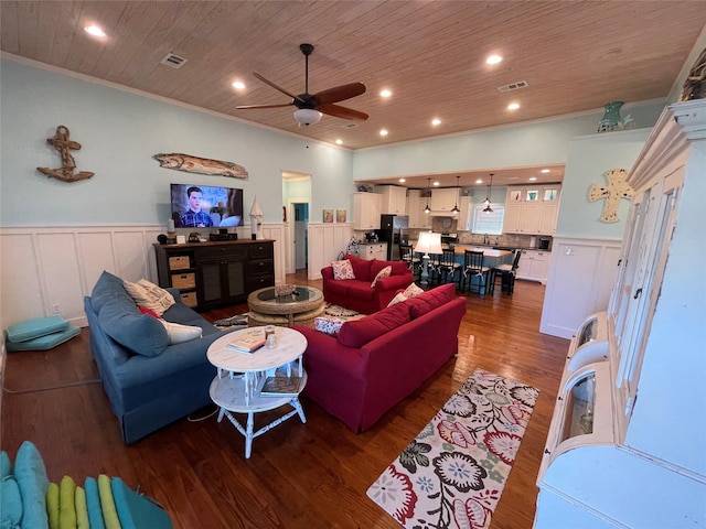 living room with crown molding, ceiling fan, dark wood-type flooring, and wood ceiling