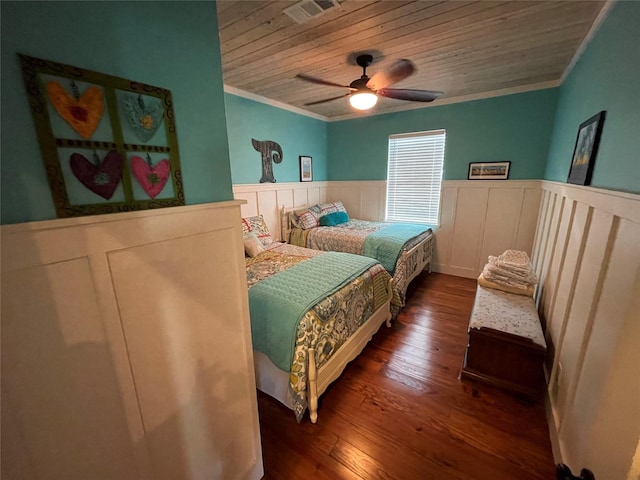 bedroom with dark hardwood / wood-style flooring, wooden ceiling, ceiling fan, and ornamental molding