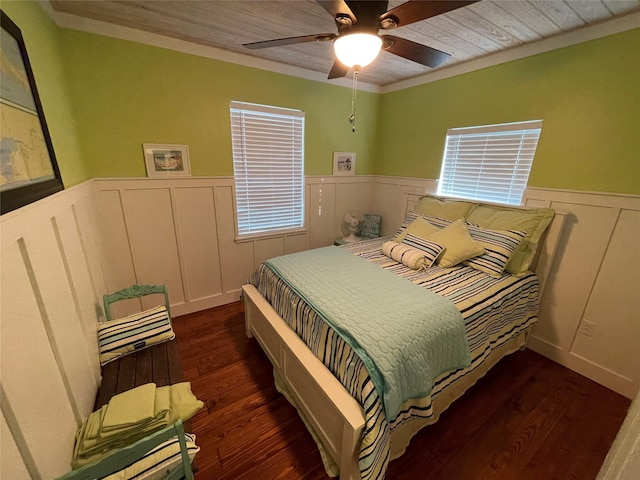 bedroom with ceiling fan, dark hardwood / wood-style floors, and crown molding