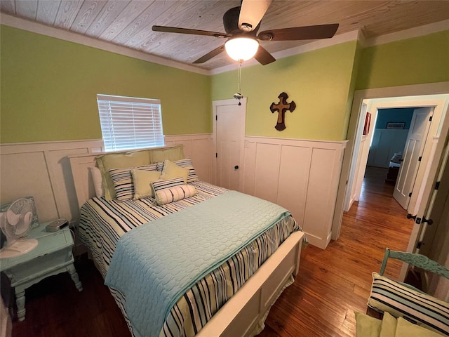 bedroom with ceiling fan, crown molding, hardwood / wood-style floors, and wooden ceiling