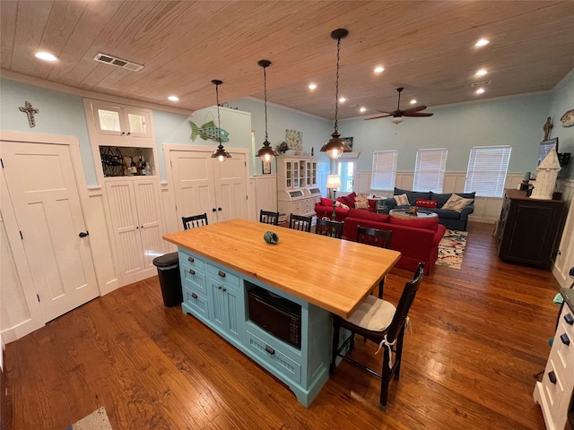 kitchen with visible vents, white cabinets, wood ceiling, hanging light fixtures, and wooden counters