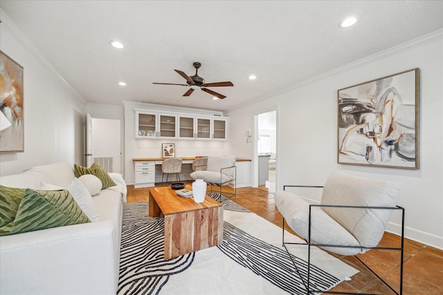 living room with ceiling fan, built in desk, crown molding, and light tile patterned floors