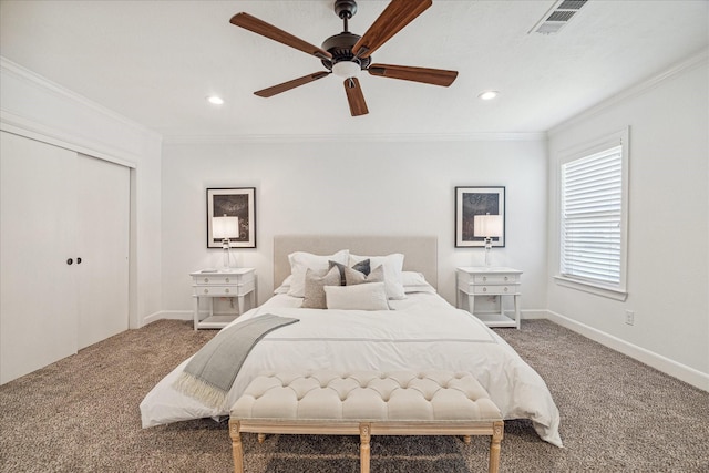 carpeted bedroom featuring ceiling fan, ornamental molding, and a closet