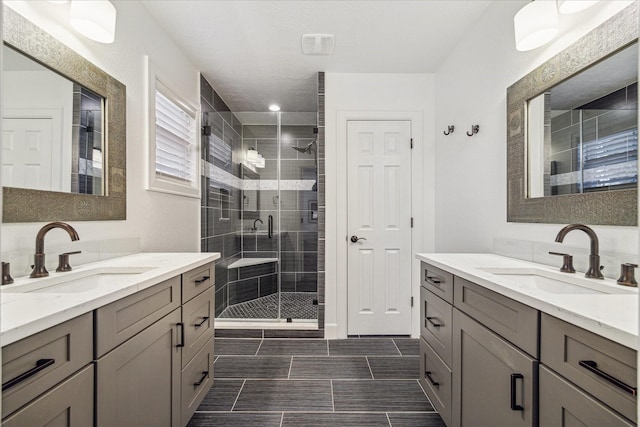 bathroom with vanity and a shower with shower door