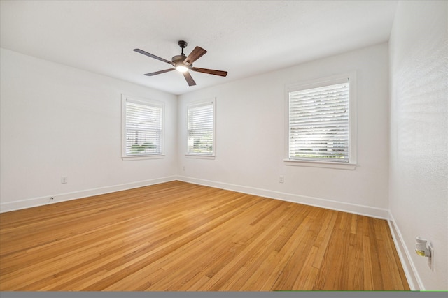 spare room featuring ceiling fan, a healthy amount of sunlight, and light hardwood / wood-style floors