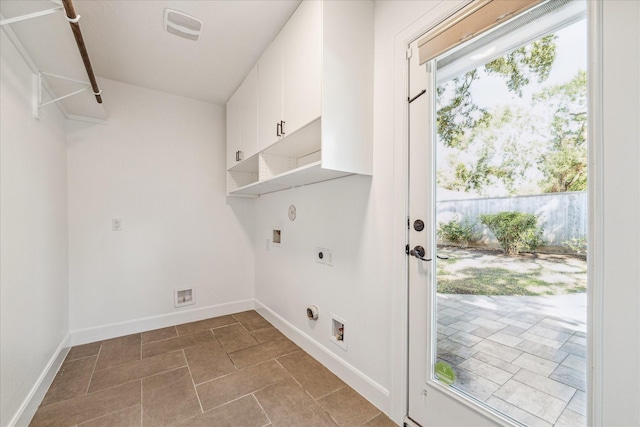 clothes washing area with a wealth of natural light, cabinets, washer hookup, and hookup for an electric dryer