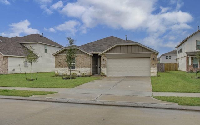 view of front of property with a garage and a front lawn