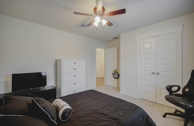 bedroom featuring ceiling fan, a closet, and light carpet