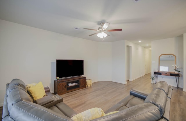 living room with light hardwood / wood-style flooring and ceiling fan