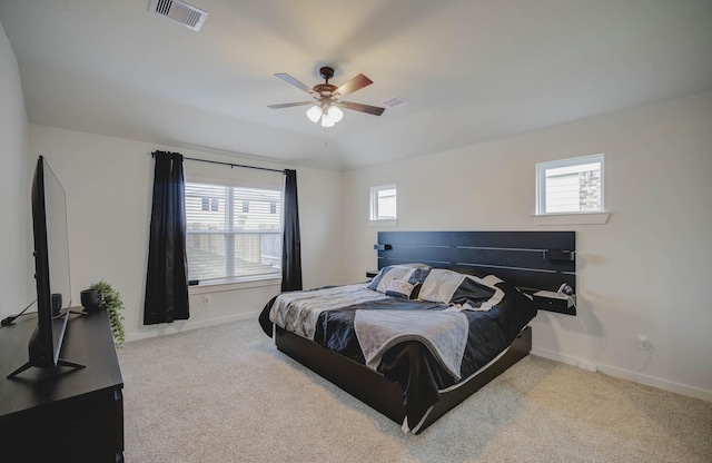 carpeted bedroom featuring multiple windows, vaulted ceiling, and ceiling fan