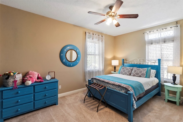 carpeted bedroom with a textured ceiling and ceiling fan