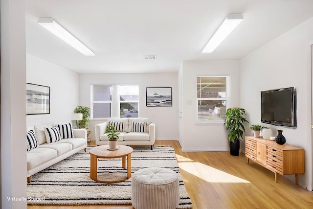 living room with light hardwood / wood-style flooring