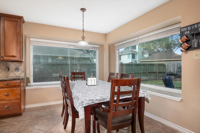 dining space featuring a healthy amount of sunlight and light tile patterned floors