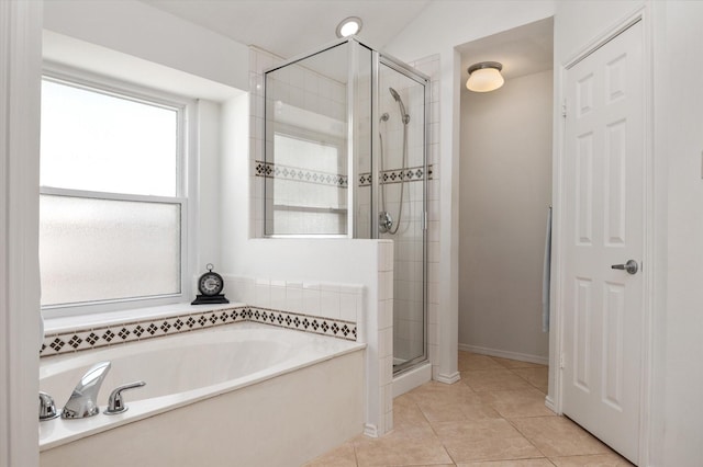 bathroom featuring tile patterned floors and independent shower and bath