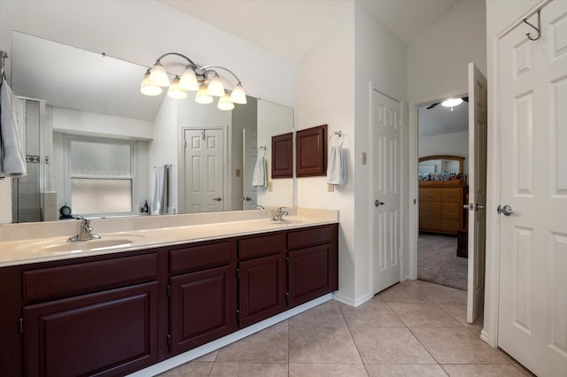 bathroom featuring vanity, tile patterned floors, and vaulted ceiling