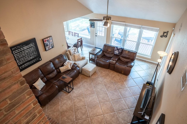 living room with light tile patterned floors, vaulted ceiling, and ceiling fan