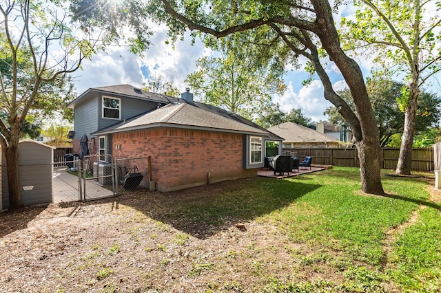 back of property with a yard and a patio area