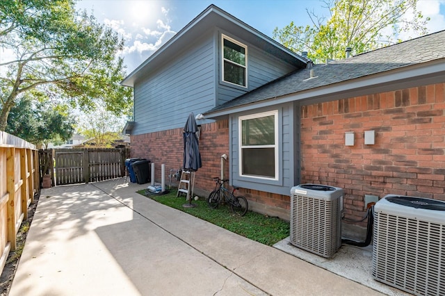 rear view of house featuring a patio and central AC