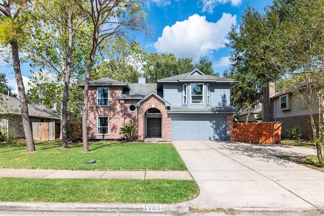 view of front of house featuring a garage and a front lawn