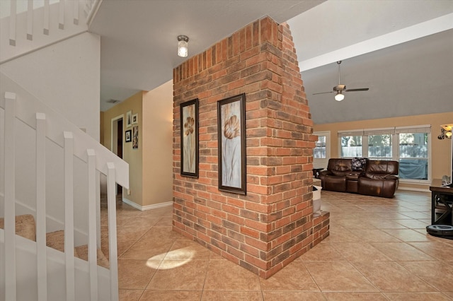 interior space featuring light tile patterned flooring and lofted ceiling