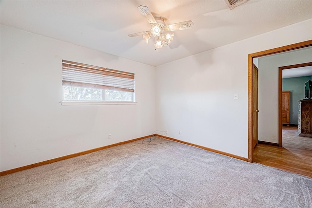 unfurnished room with ceiling fan and carpet