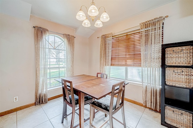 tiled dining area with a chandelier and vaulted ceiling