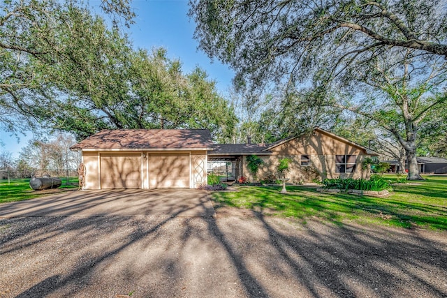 ranch-style home featuring a front yard and a garage