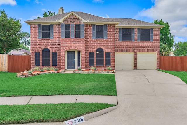 view of front of property featuring a garage and a front yard