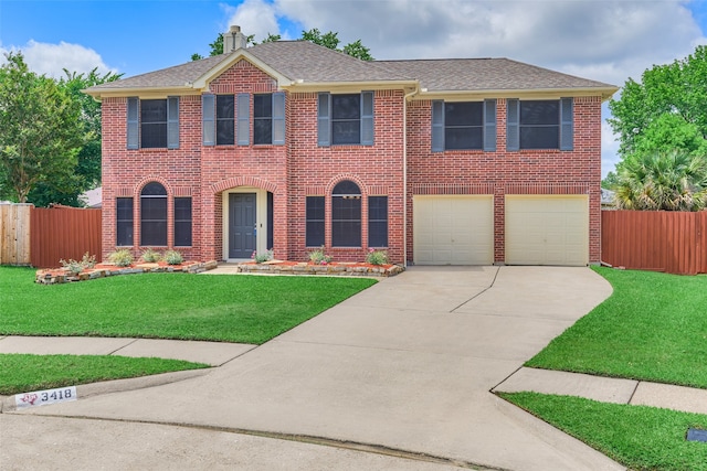 view of front of house with a garage and a front lawn