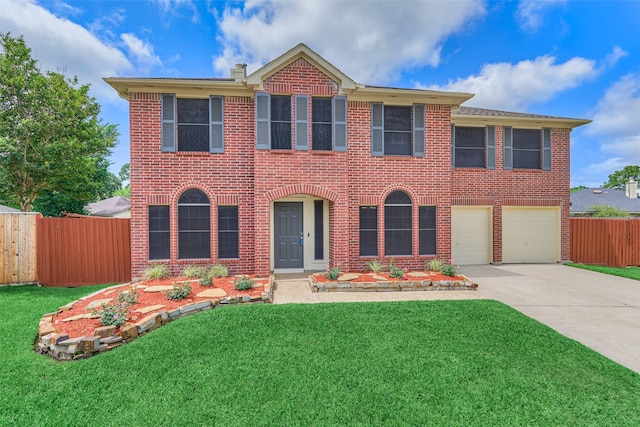 view of front of house with a garage and a front lawn