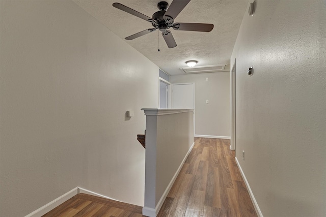 hall featuring a textured ceiling and hardwood / wood-style flooring