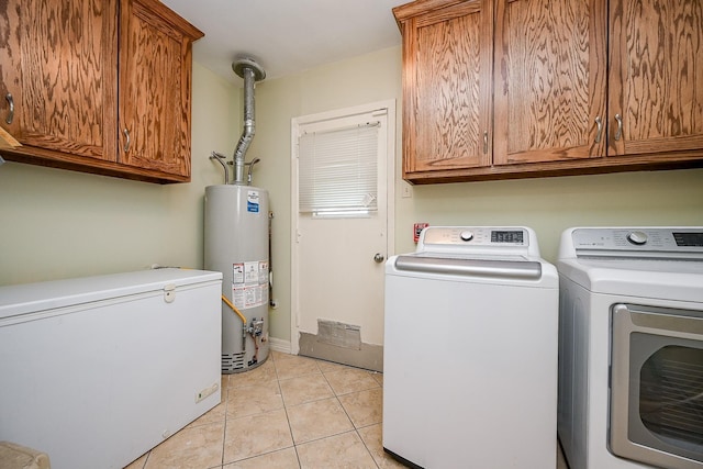 washroom featuring cabinets, independent washer and dryer, gas water heater, and light tile patterned flooring