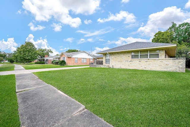 view of side of property featuring a yard