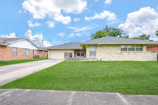 single story home with cooling unit, a garage, and a front yard