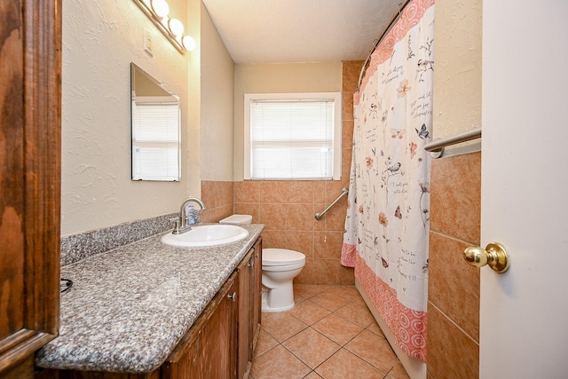 bathroom with tile patterned flooring, vanity, and toilet