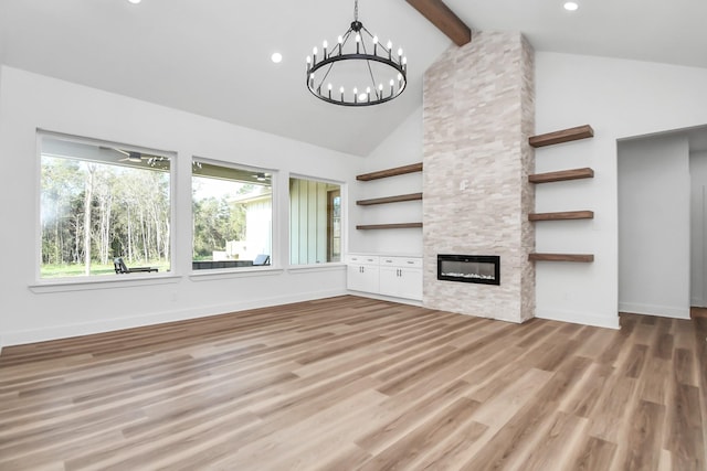 unfurnished living room featuring a stone fireplace, hardwood / wood-style floors, an inviting chandelier, and vaulted ceiling with beams