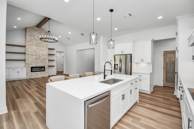 kitchen featuring sink, white cabinetry, a kitchen island with sink, and stainless steel appliances