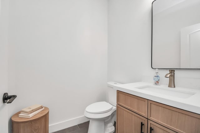 bathroom featuring tile patterned floors, vanity, and toilet