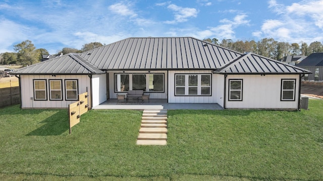 rear view of house featuring a yard and a patio