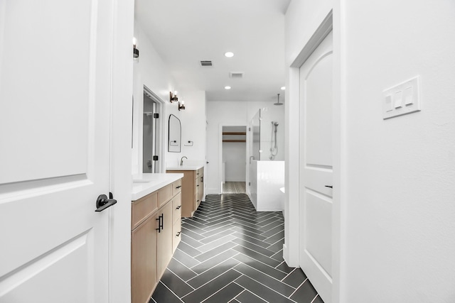 bathroom featuring a shower and vanity