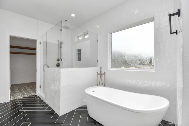 bathroom featuring tile patterned flooring and shower with separate bathtub