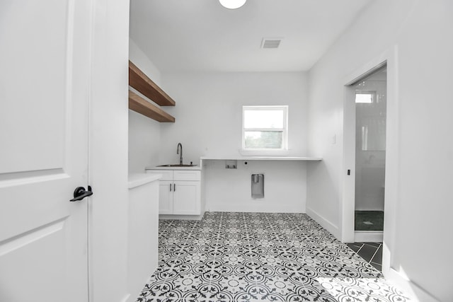 clothes washing area featuring hookup for an electric dryer, cabinets, sink, and hookup for a washing machine